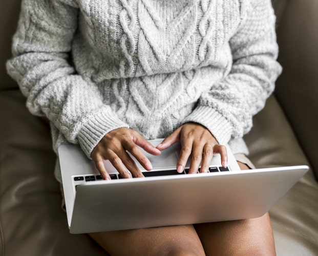 photo of a woman working on a laptop